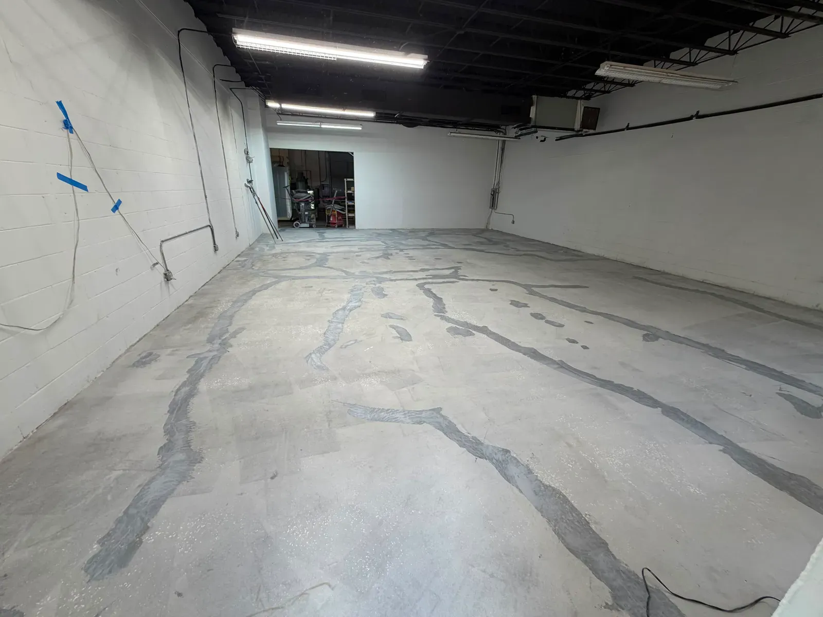 Bare concrete slab with cracks before any work