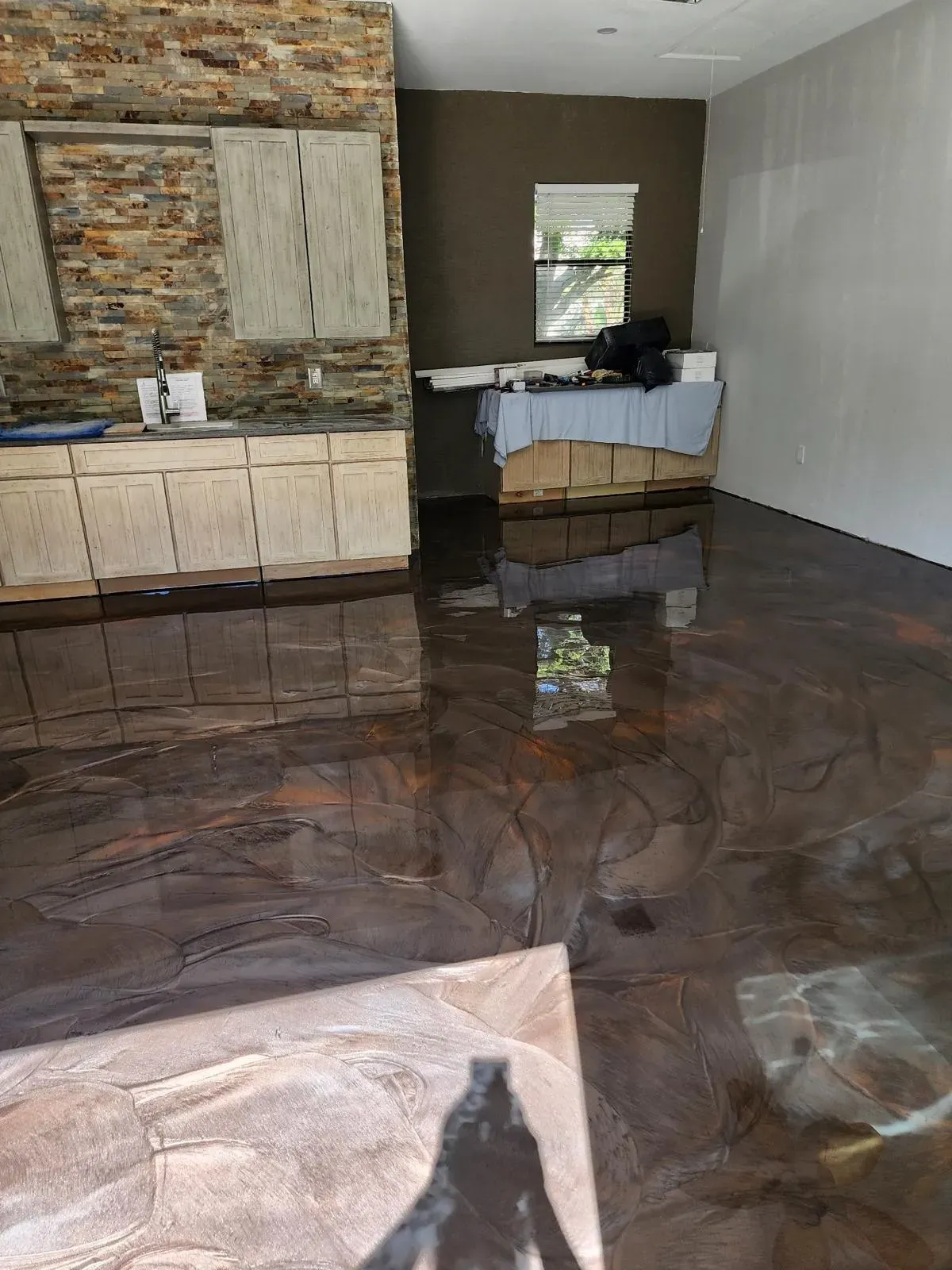 Copper metallic epoxy in an open living and kitchen area