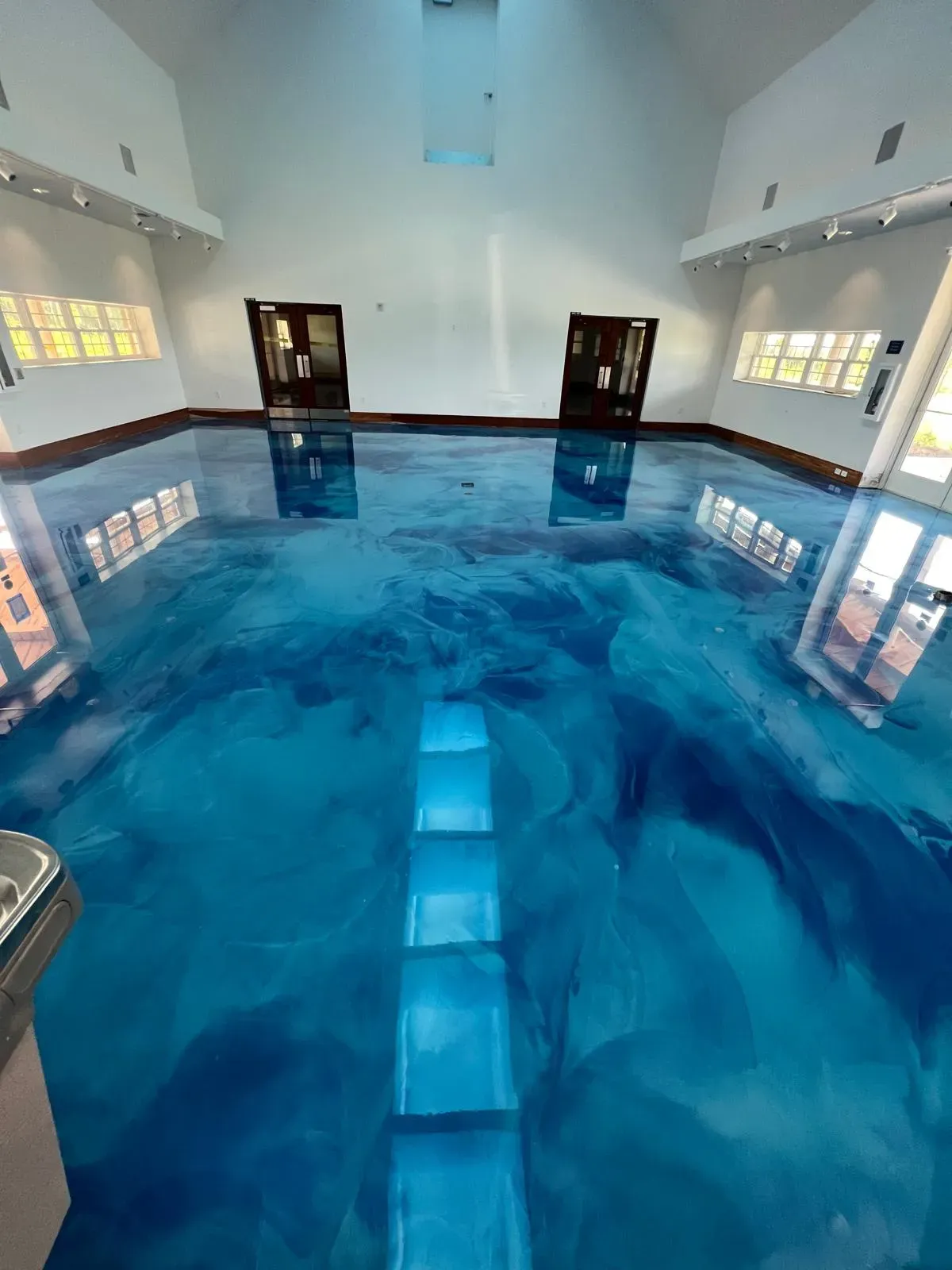 Blue metallic epoxy floor in a pool house